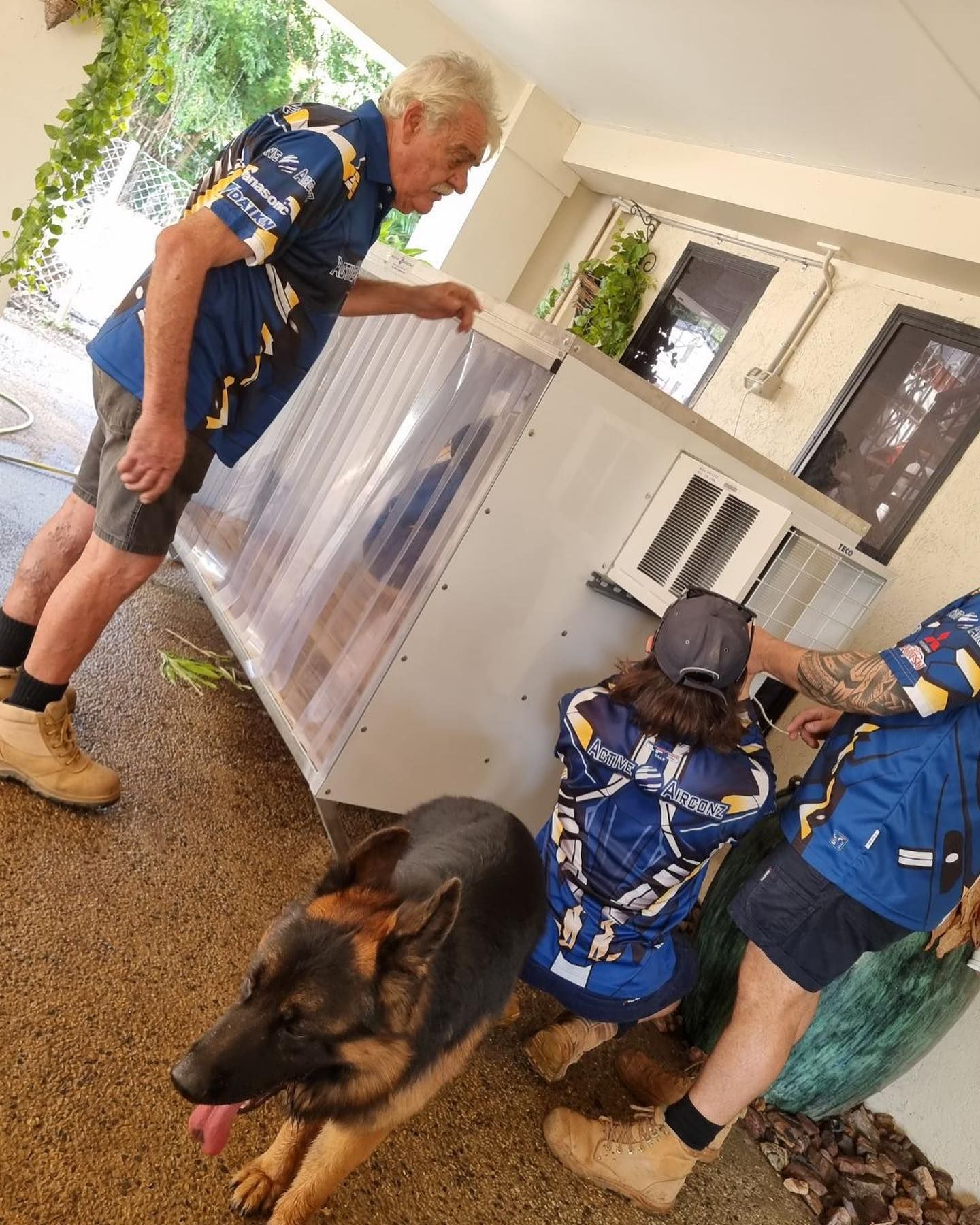 People and Dog Near a Large Metal Cabinet — Active Airconz in Nhulunbuy, NT