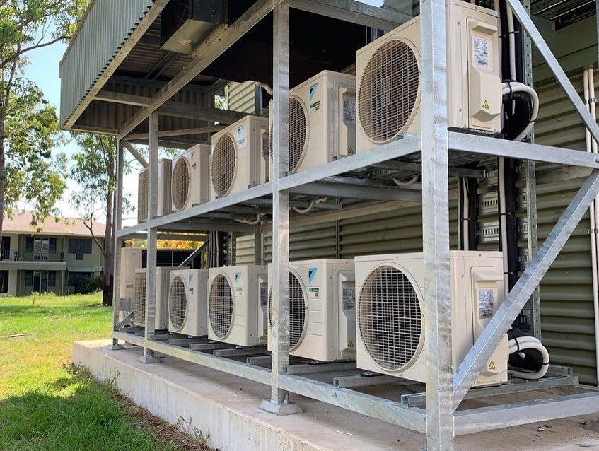 Air Conditioning Units on Metal Shelving Outside a Building — Active Airconz in Toowoomba, QLD