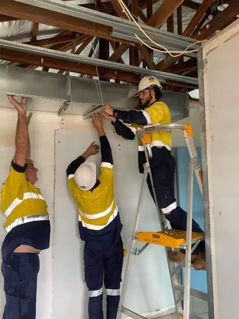 Three Workers Install Ductwork — Active Airconz In Rockhampton, QLD