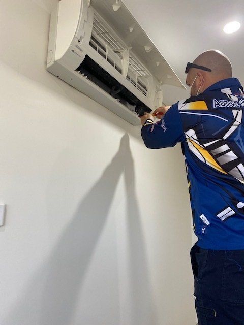 Technician Fixing and Cleaning the Air-condition —  Air Conditioning in Darwin