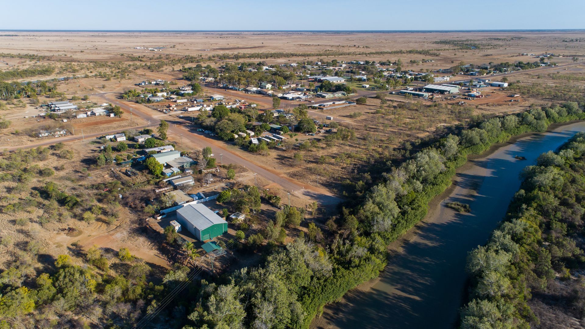 Aerial View of a Remote Town Near a River, Surrounded by Arid Landscape — Active Airconz in Burketown, QLD