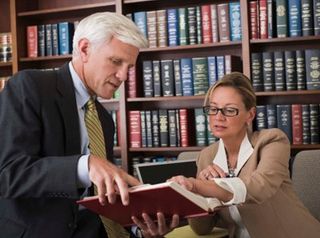 Lawyers researching in a library — Debt Relief Attorney in Mobile, AL
