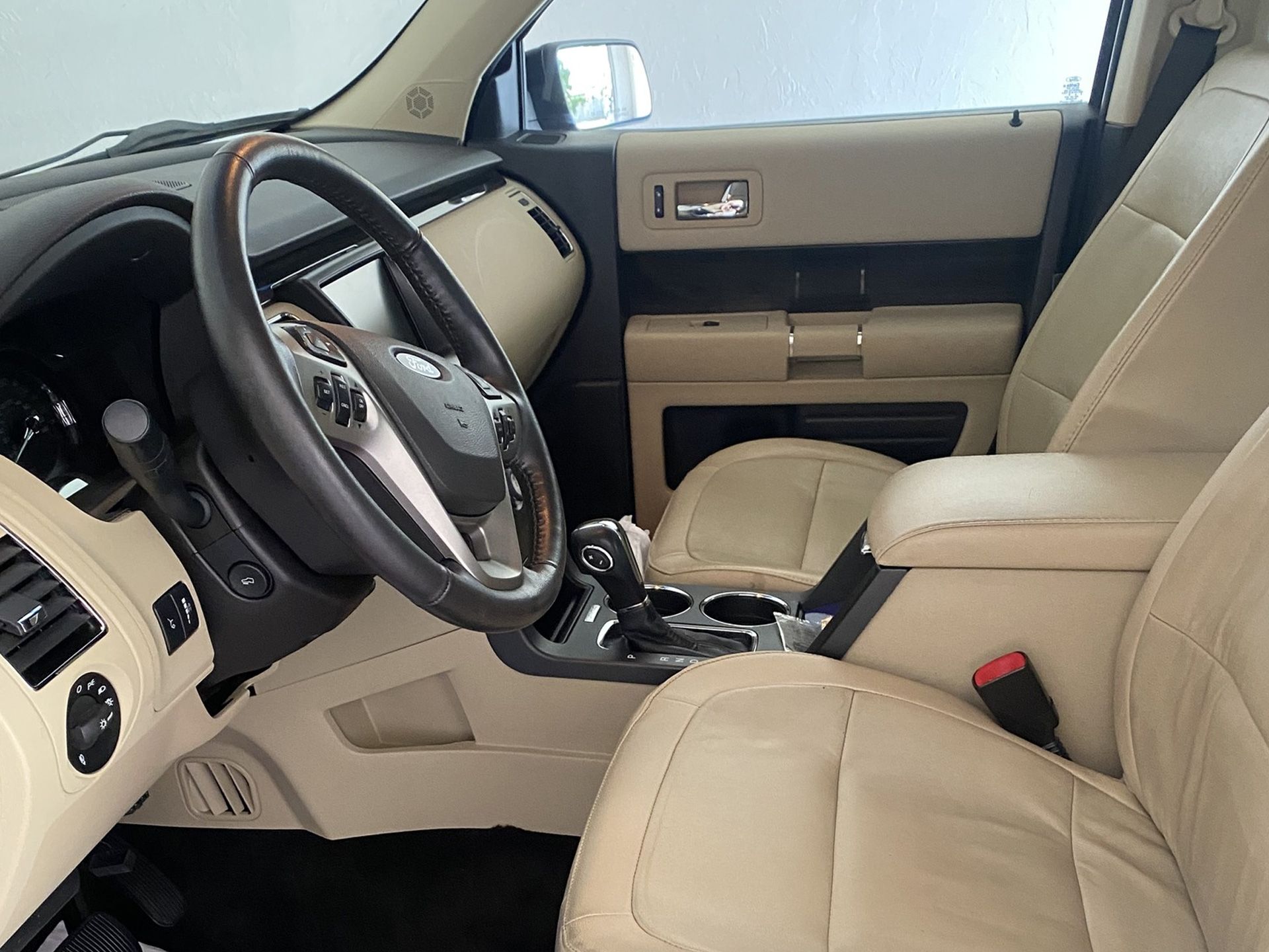 The interior of a ford flex with tan leather seats being cleaned