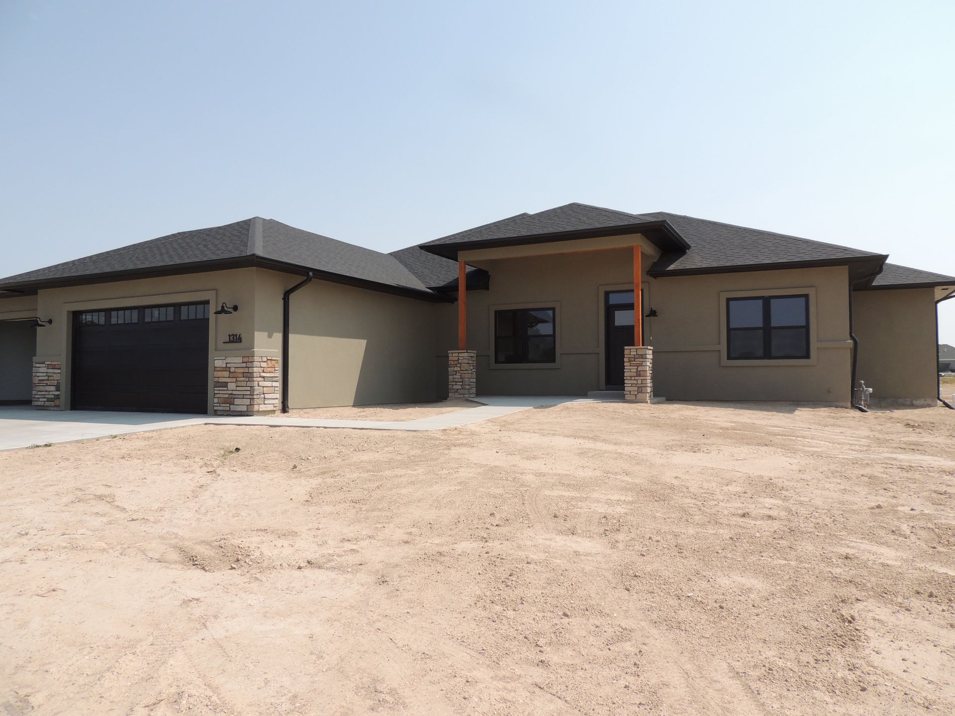 A large house with a garage and a porch