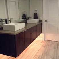 A bathroom with two sinks and a mirror.