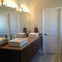A bathroom with two sinks and a large mirror.
