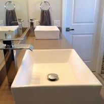 A bathroom with two sinks and a mirror.