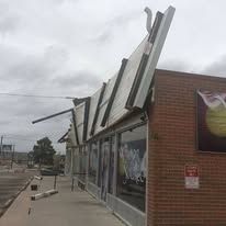 A brick building with a large billboard on the side of it.