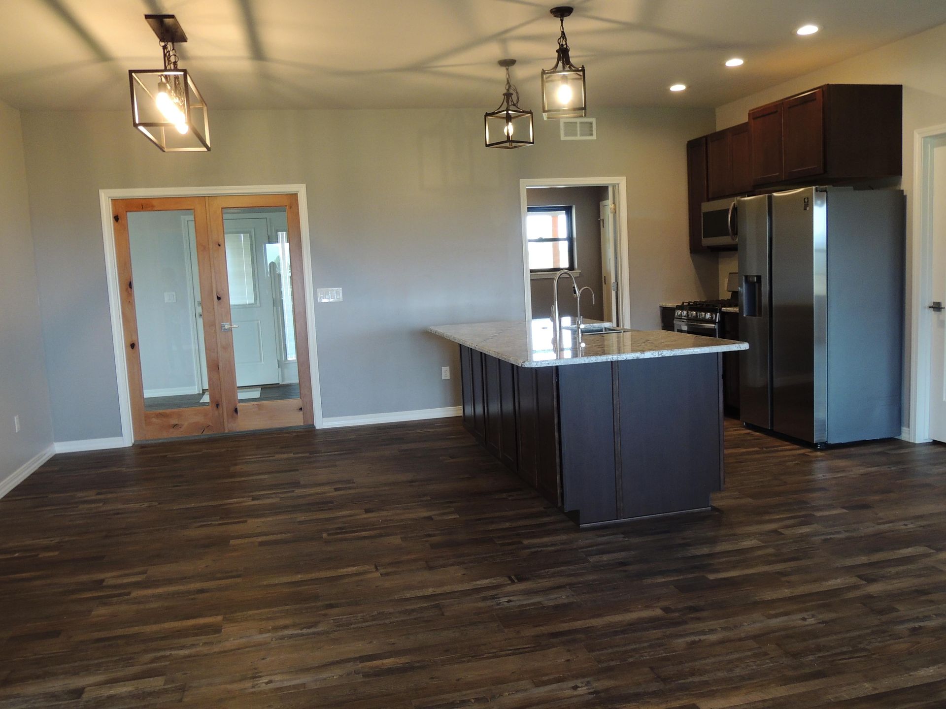 A kitchen with a large island and stainless steel appliances