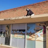 A man is standing on the roof of a building.