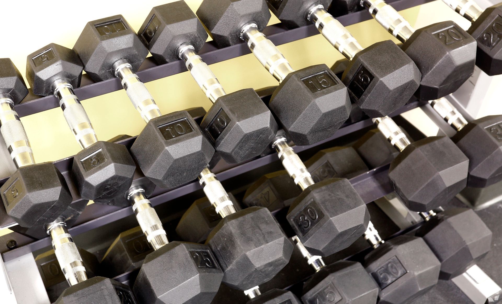 A bunch of dumbbells are stacked on top of each other