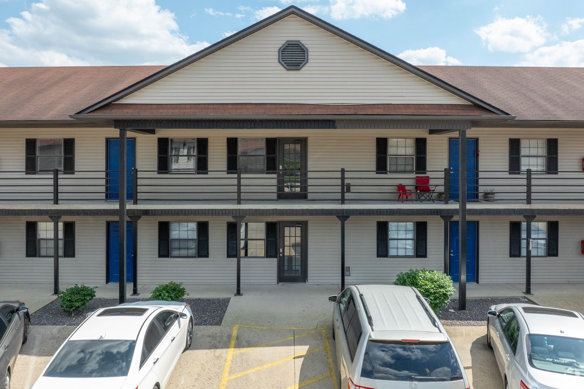 A building with a lot of cars parked in front of it