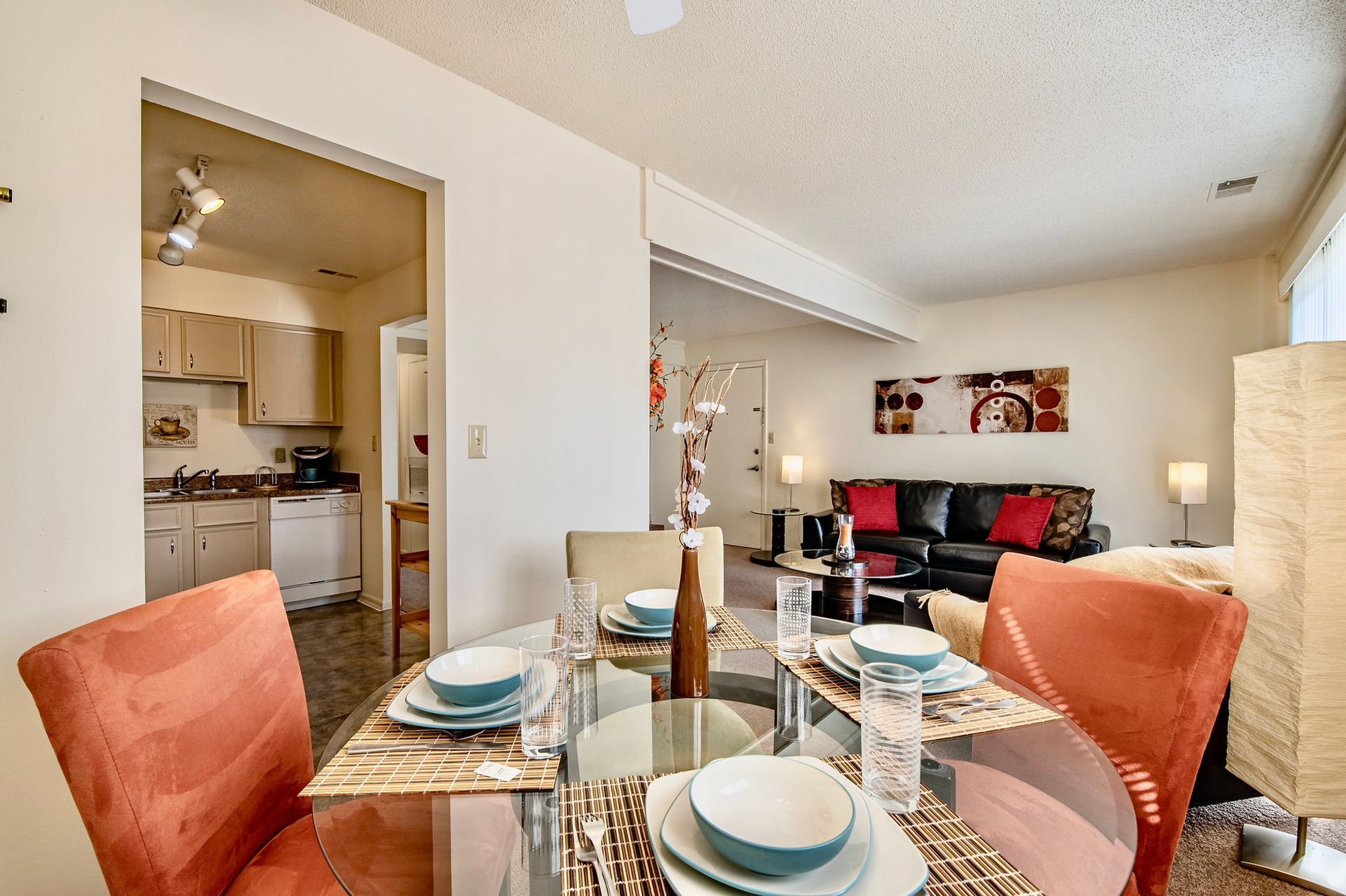 A dining room table with plates and bowls on it