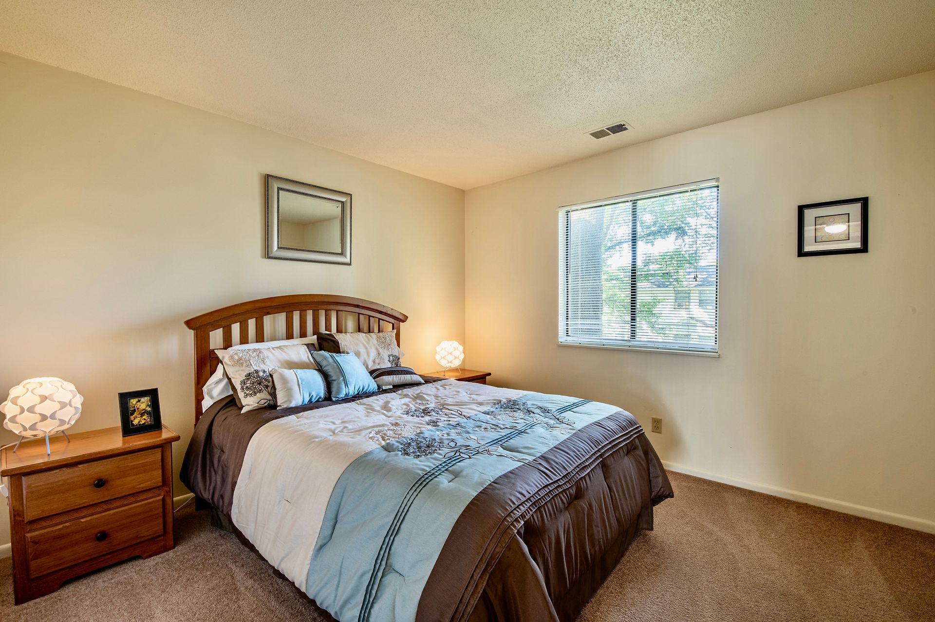 A bedroom with a large bed and a window