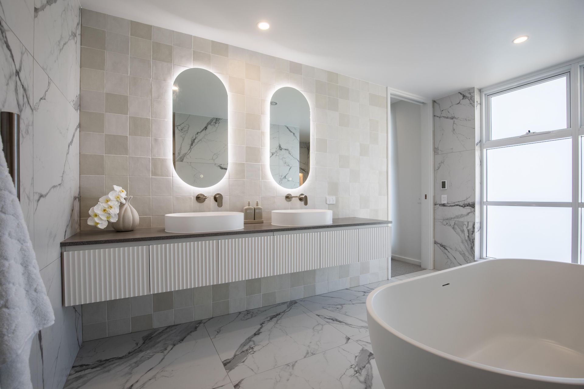 A large bathroom space with two large LED mirrors — Universal Marble & Granite In Woolgoolga, NSW