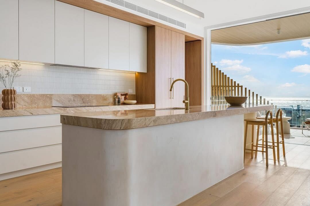 A large white kitchen space is looking out to the ocean — Universal Marble & Granite In Woolgoolga, NSW