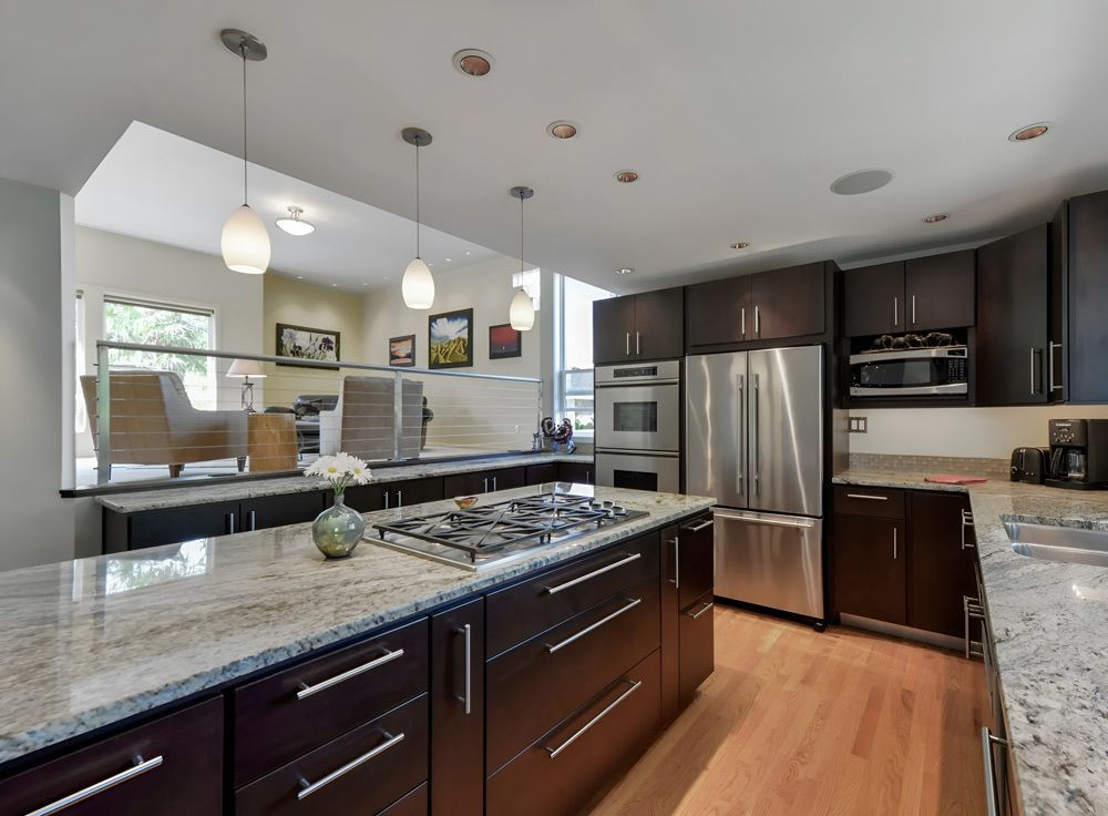 A Kitchen With Stainless Steel Appliances And Granite Counter Tops — Universal Marble & Granite In Coffs Harbour, NSW