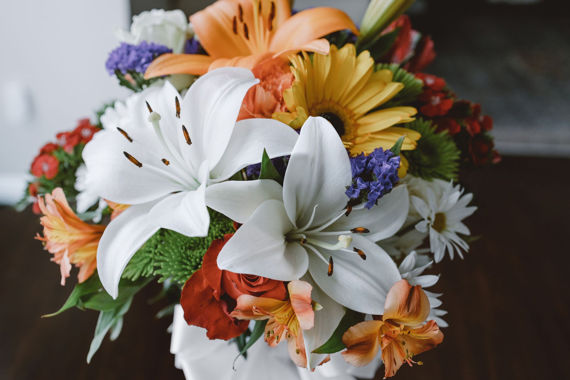 A close up of a bouquet of flowers on a table.