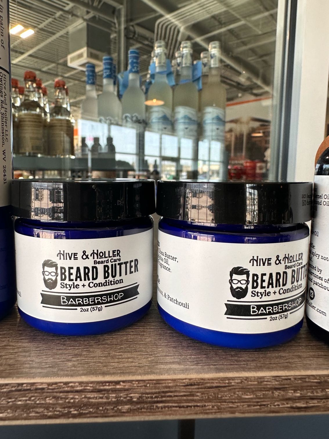 A shelf filled with lots of vases and pillows.