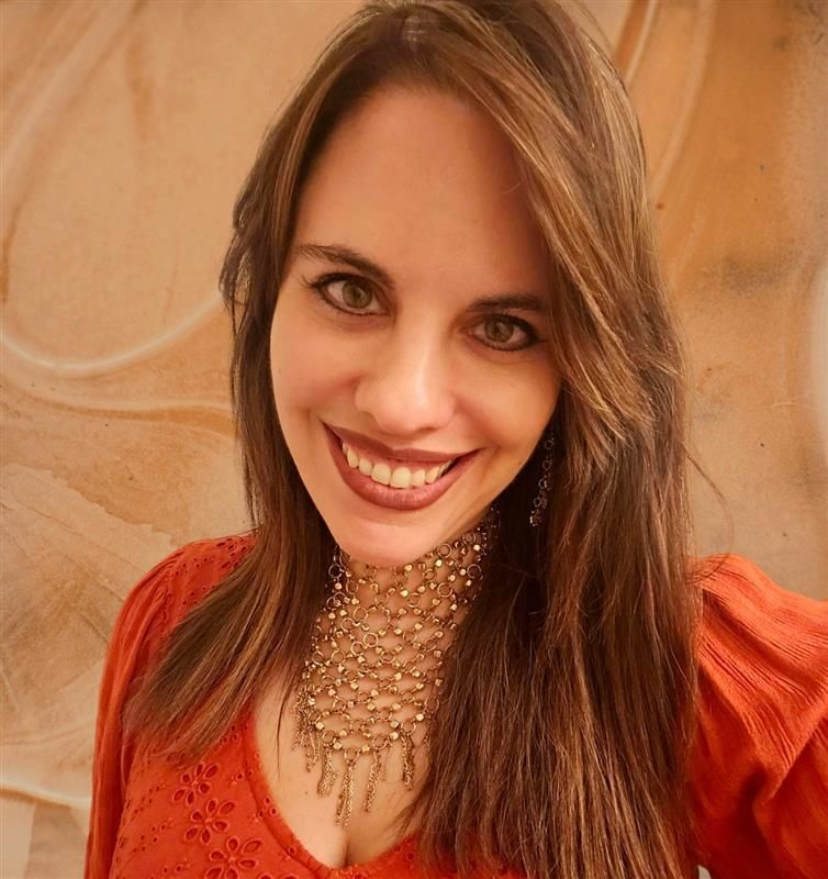 A man and a woman are sitting on a dock overlooking a lake.