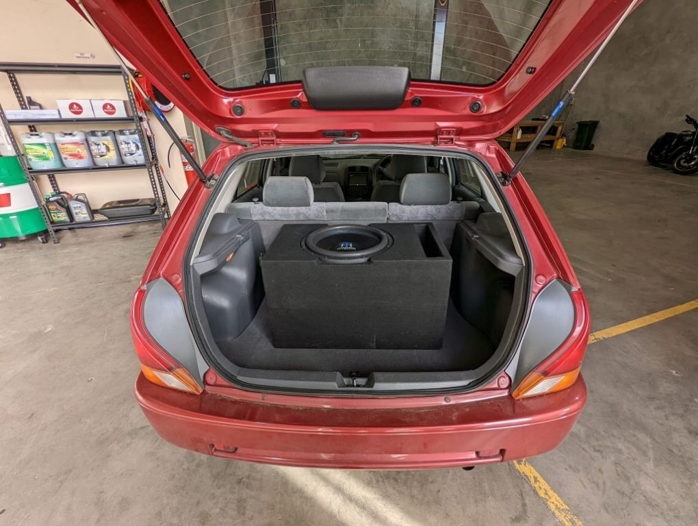 The Trunk of a Red Car With a Subwoofer in It — JJ's Garage In South Geelong, VIC