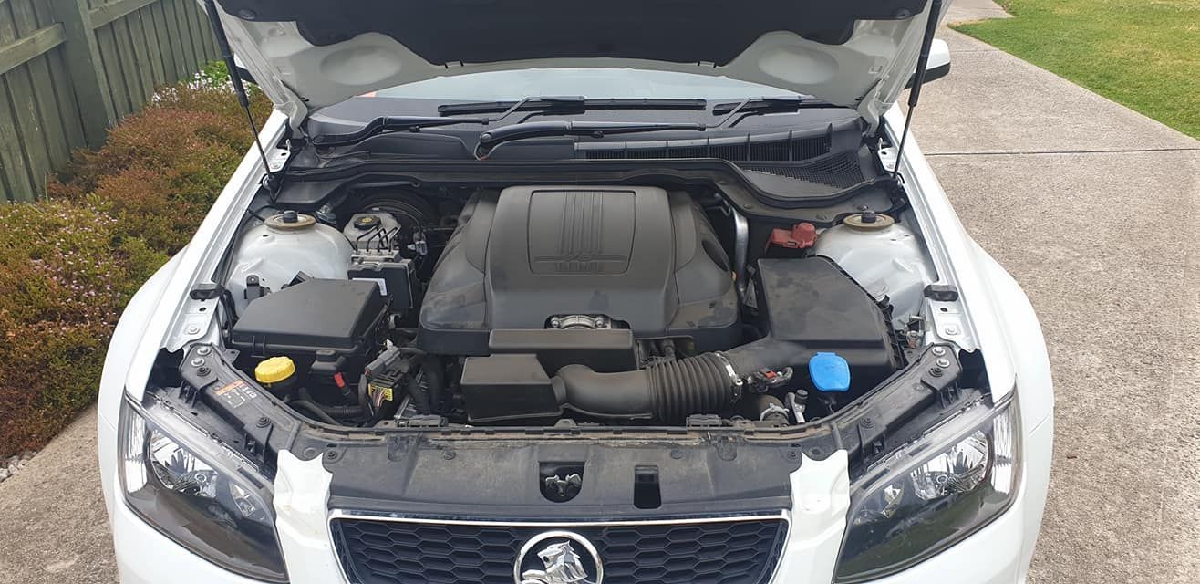 The Hood of a White Car is Open and the Engine is Visible — JJ's Garage In South Geelong, VIC