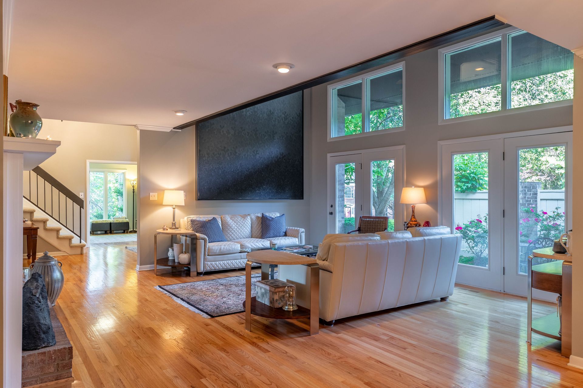 A living room with a white couch and a fireplace