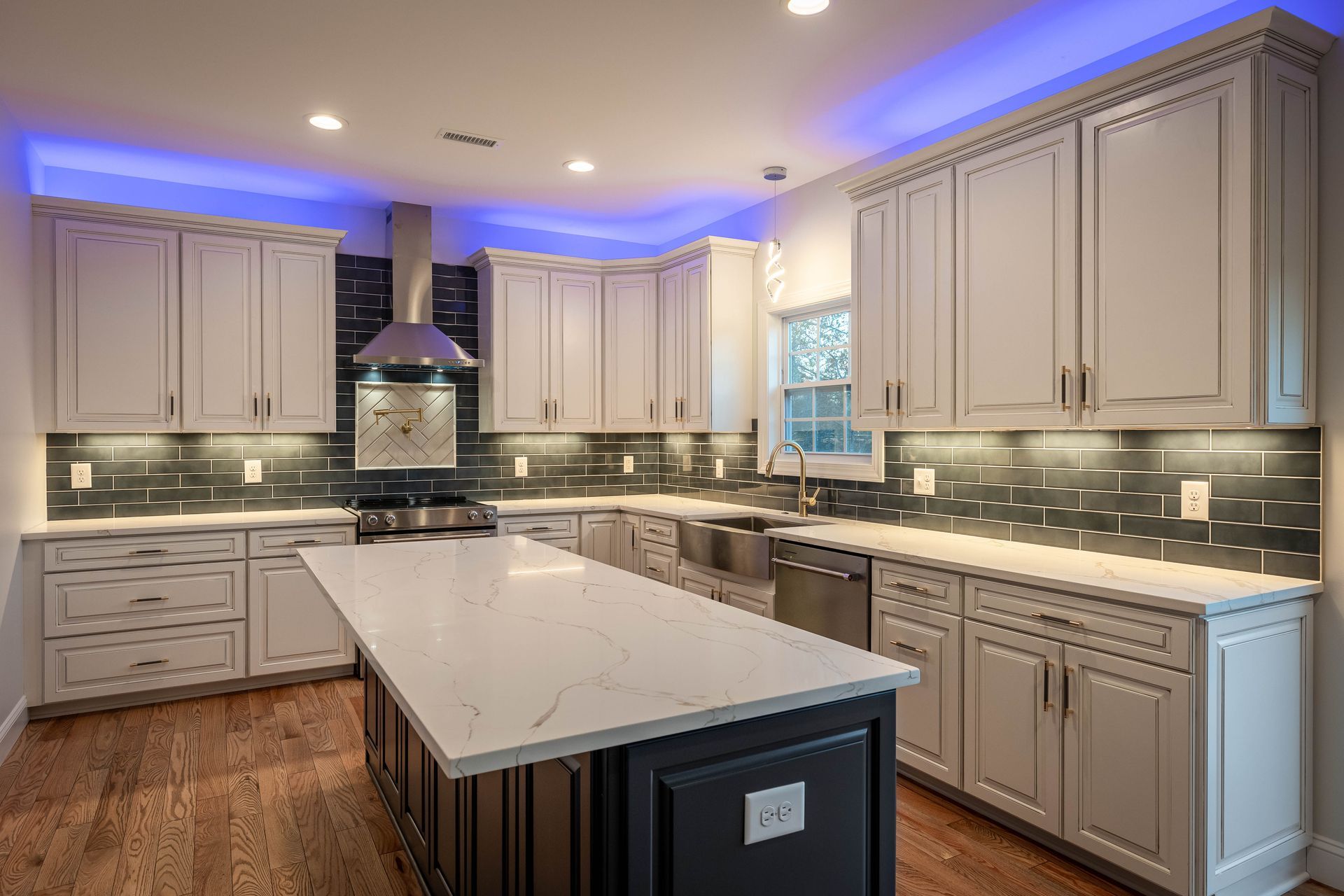 A kitchen with white cabinets and a large island