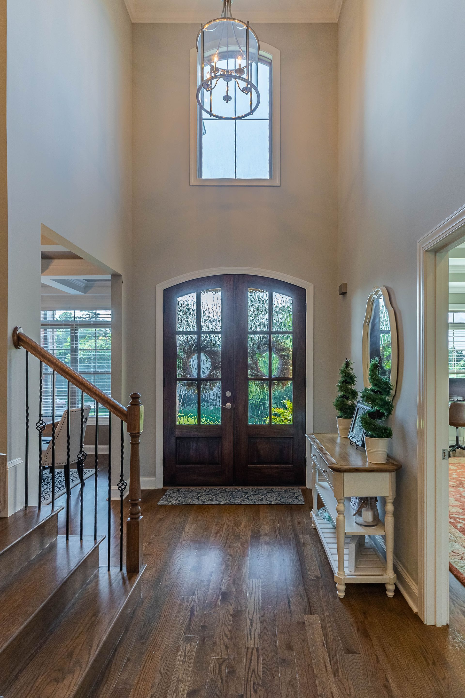 A hallway with stairs leading up to the front door