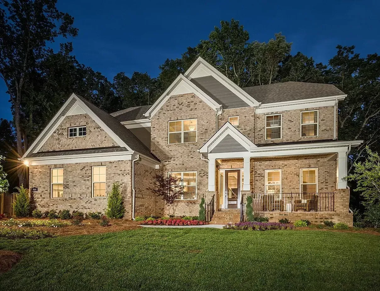 A large brick house is lit up at night