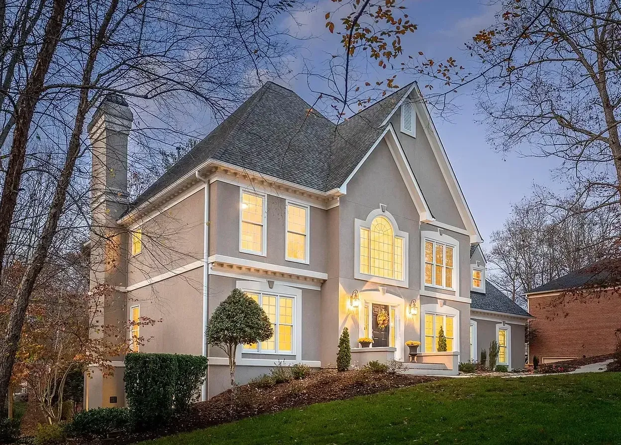 A large house with a clock on the top of it