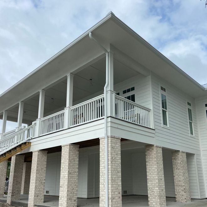 A large white house with a large porch and pillars