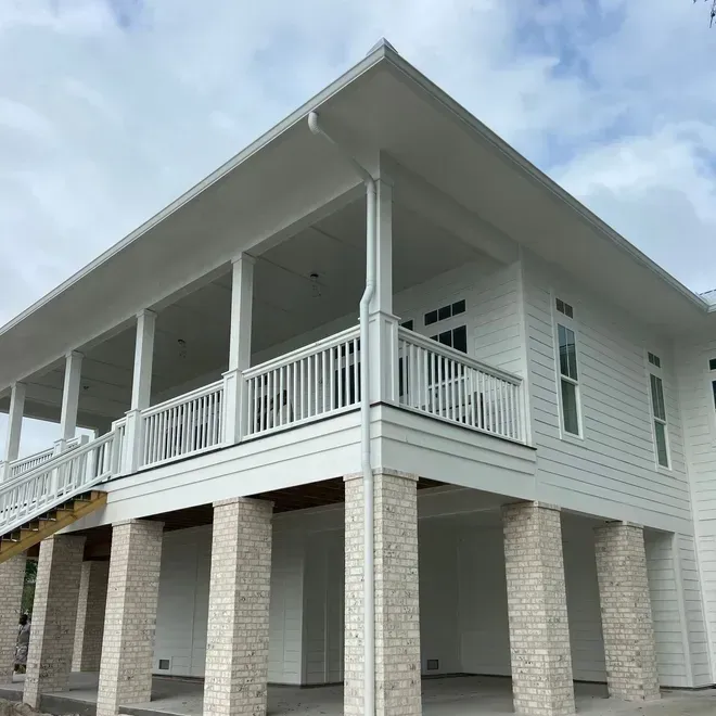 A large white house with a large porch and pillars