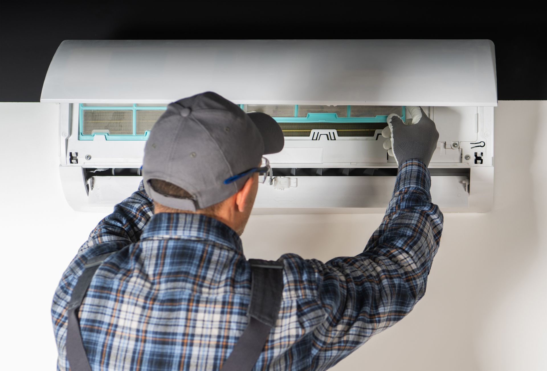 Men performing detailed AC repair work in a residential home in Cornelius, NC