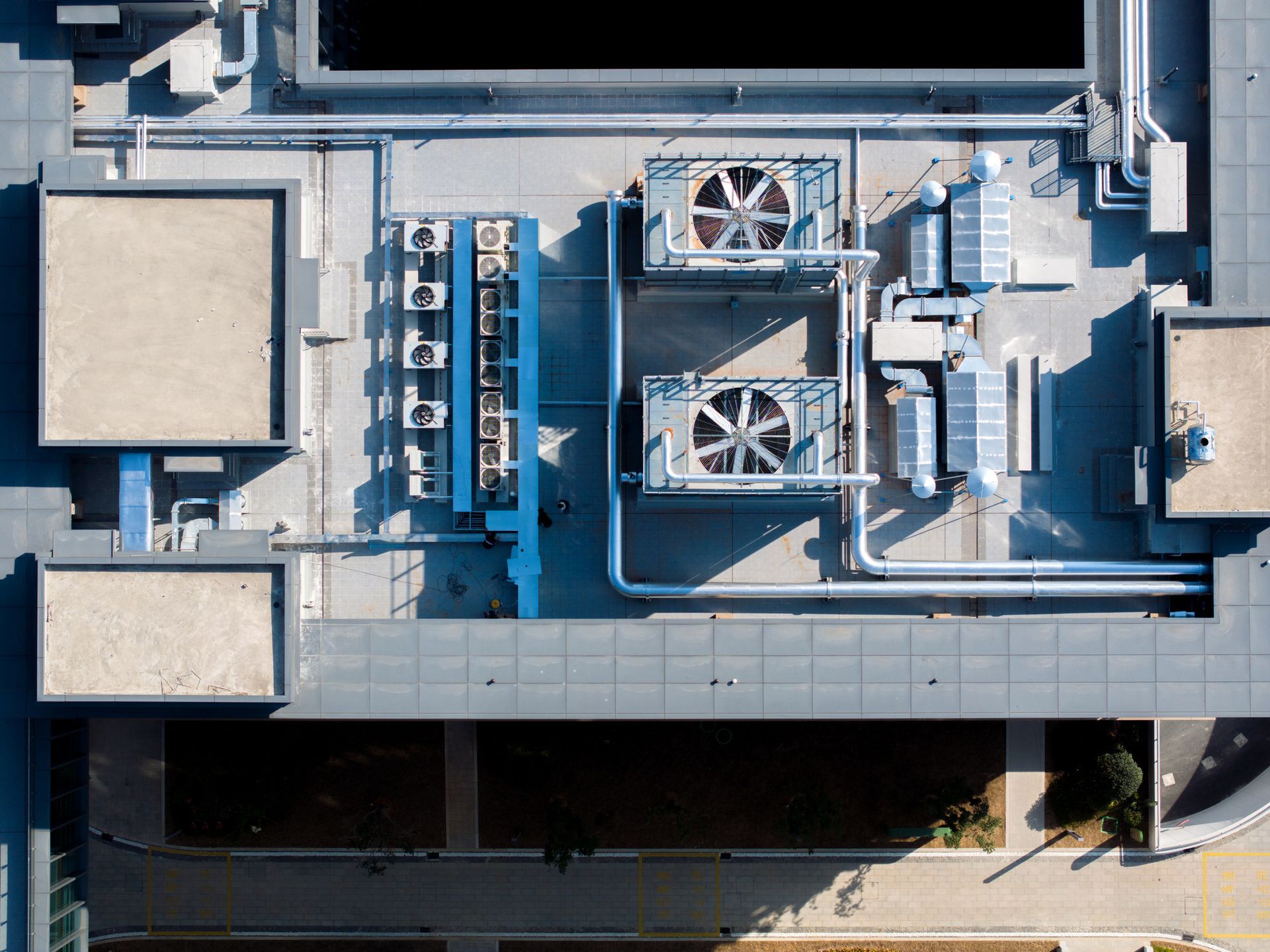 Commercial air conditioning units on a rooftop with large HVAC systems.