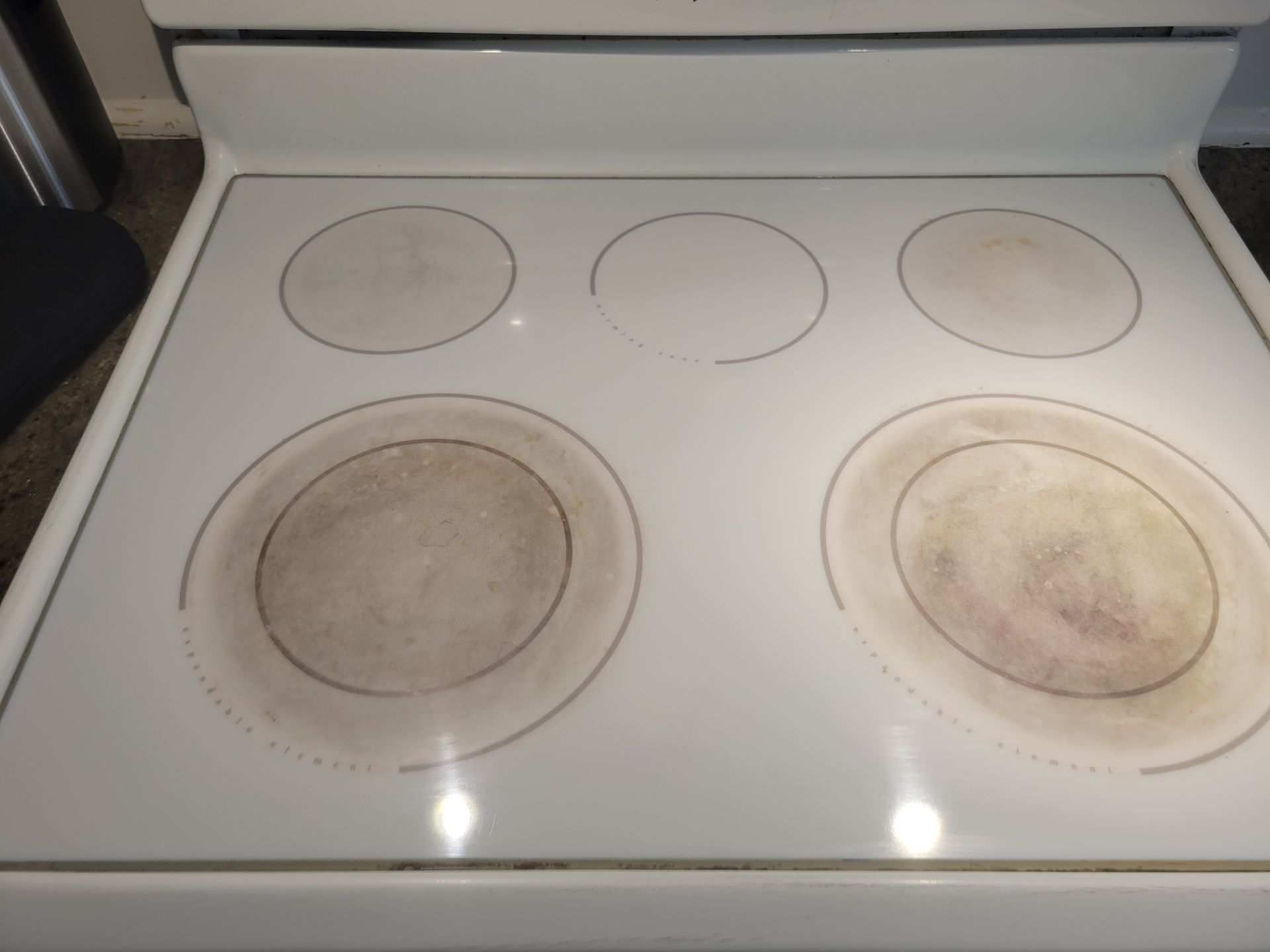 A white stove top with a lot of circles on it
