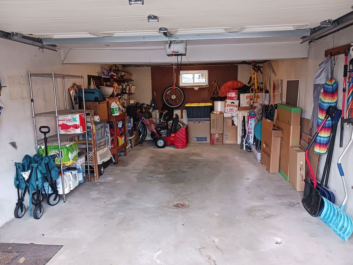 A garage filled with lots of boxes and tools.