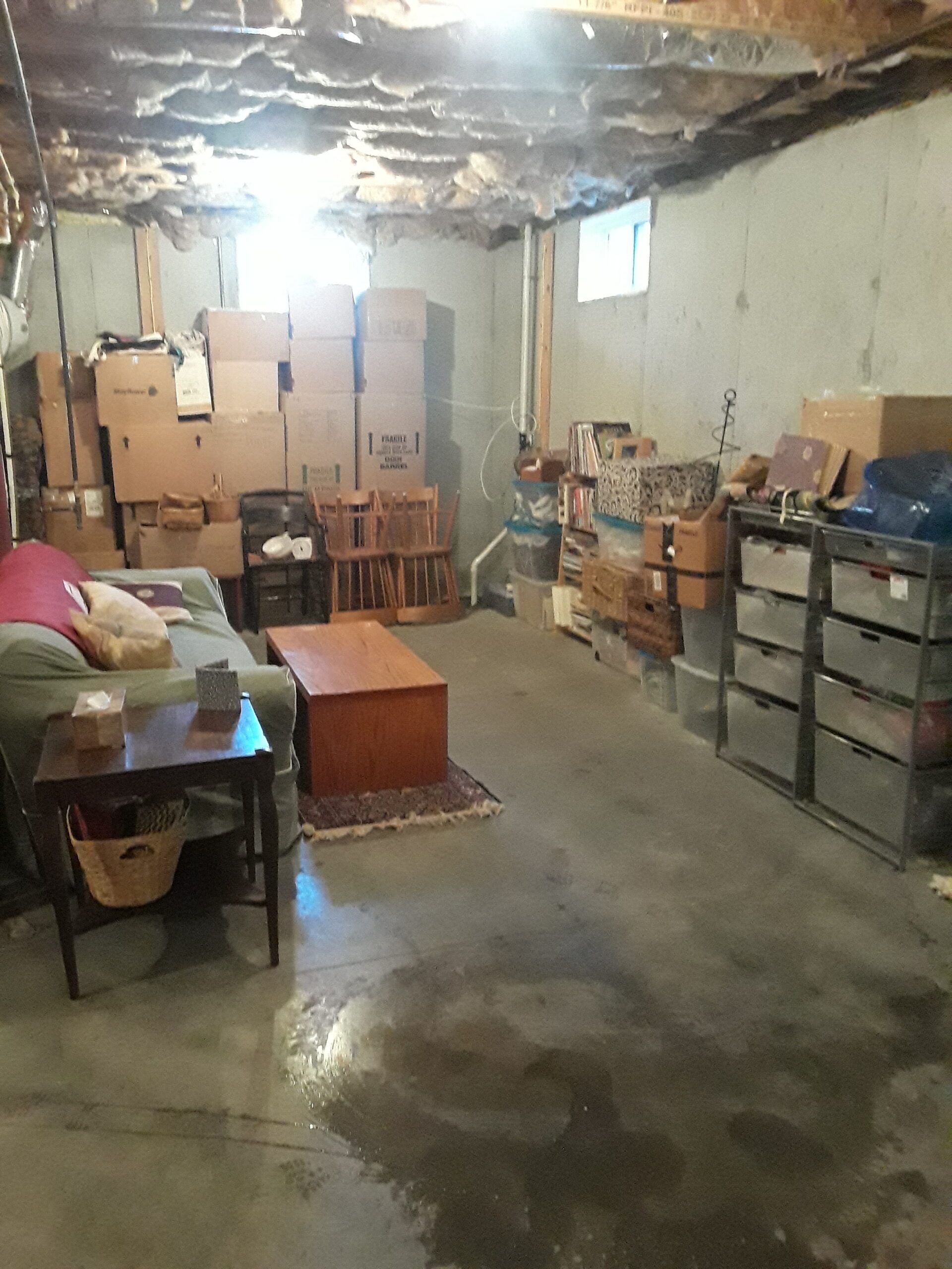 A living room filled with lots of boxes and furniture