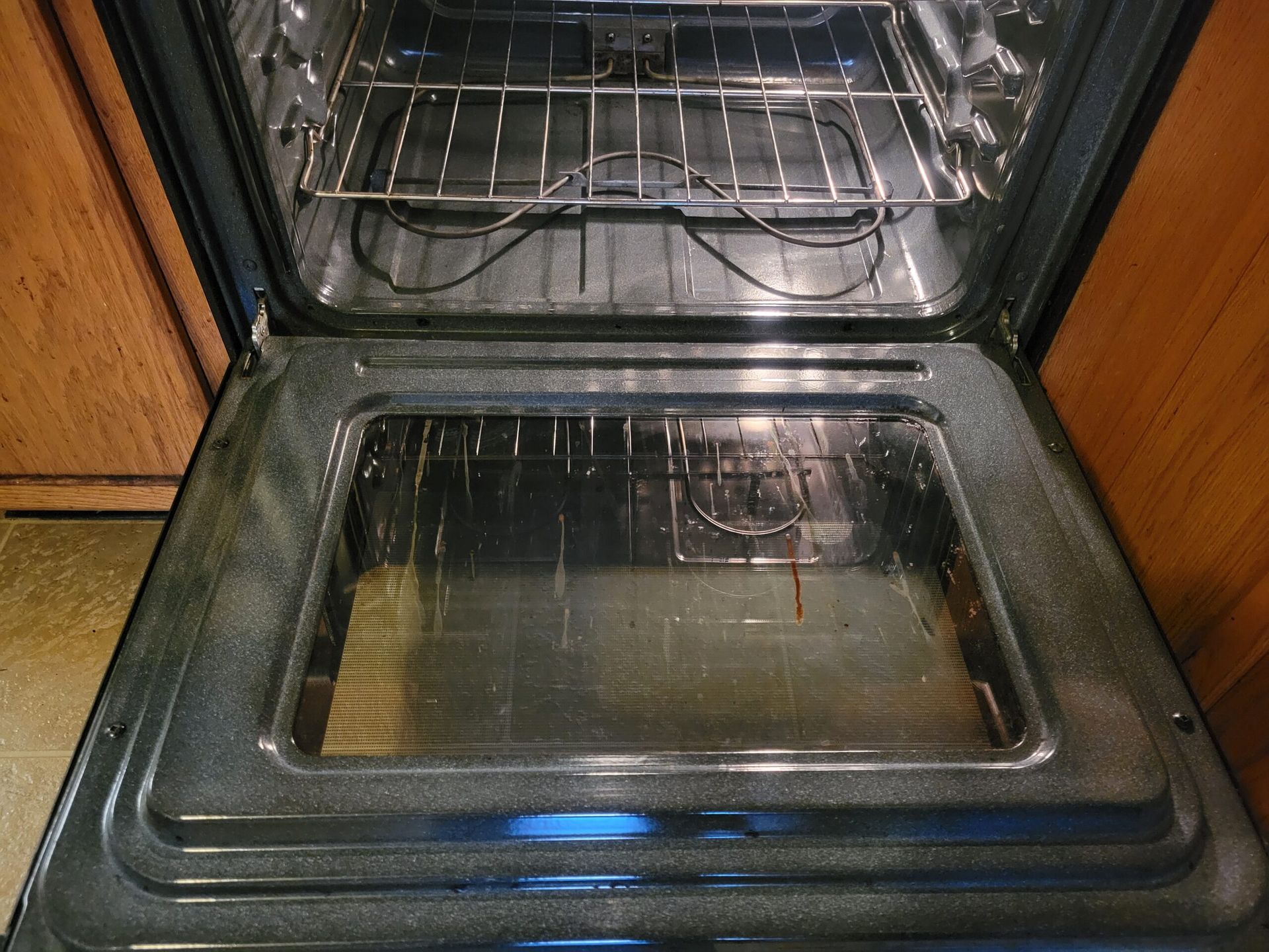 The inside of an oven is shown with the door open