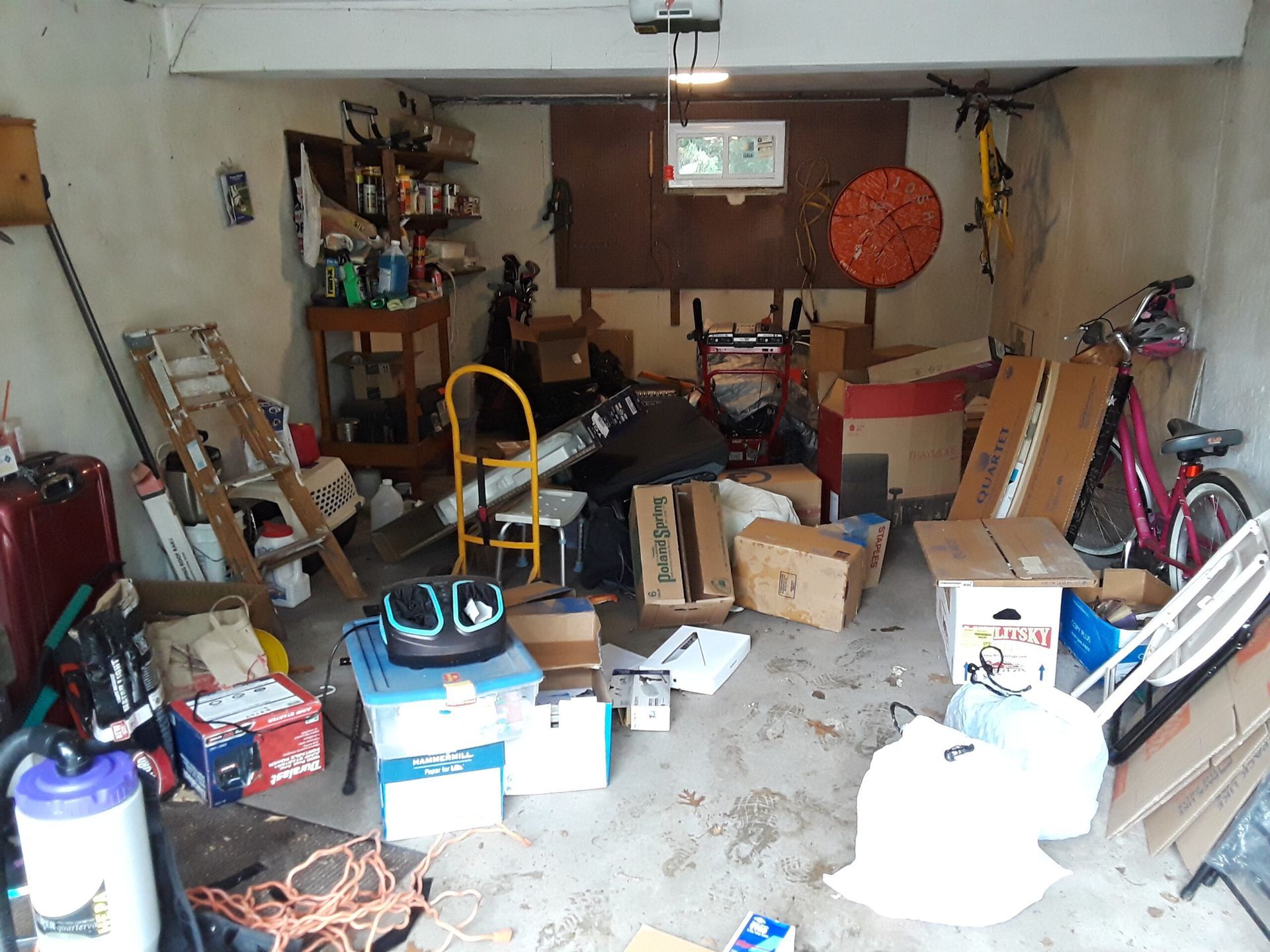 A garage filled with lots of boxes and a bicycle