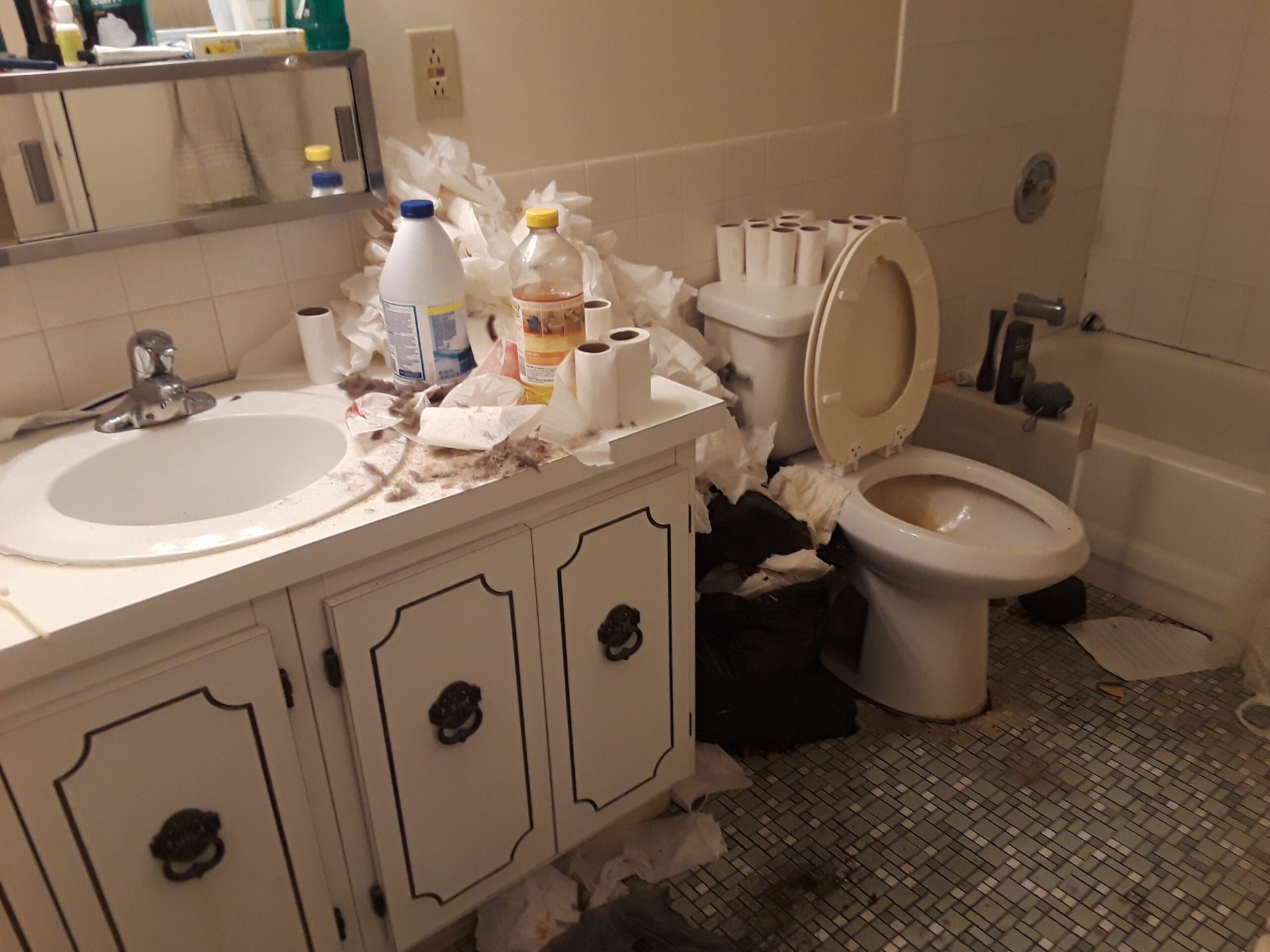 A bathroom with a toilet , sink , and bathtub