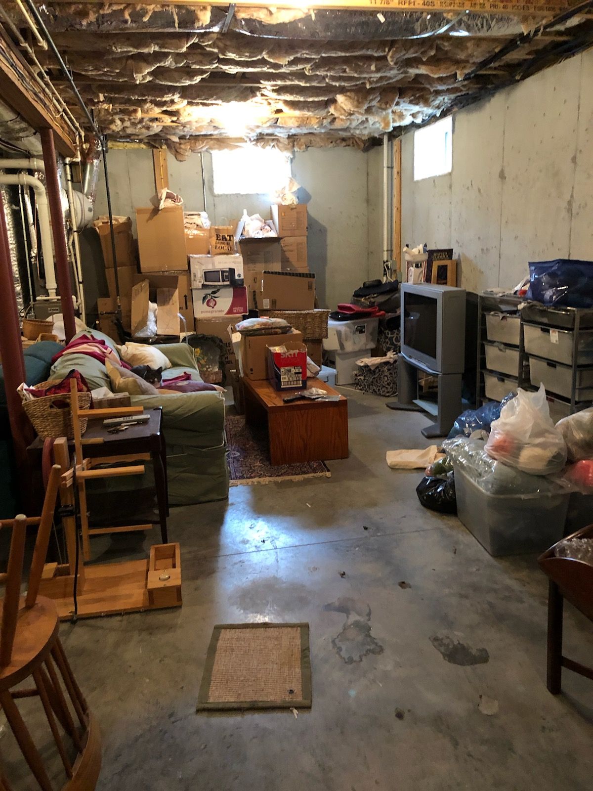 A basement filled with lots of boxes and furniture