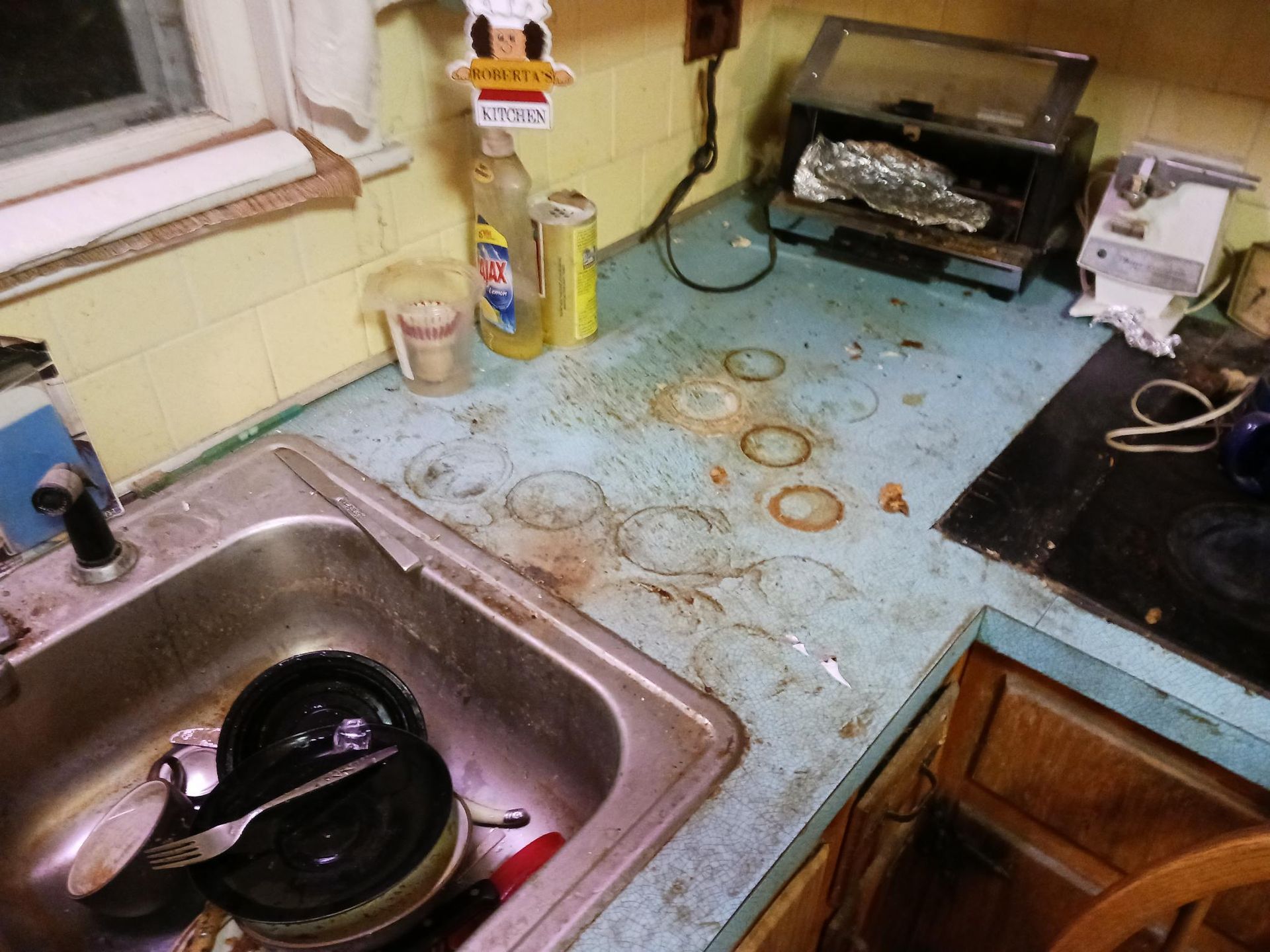 A kitchen counter with a sink and a toaster oven