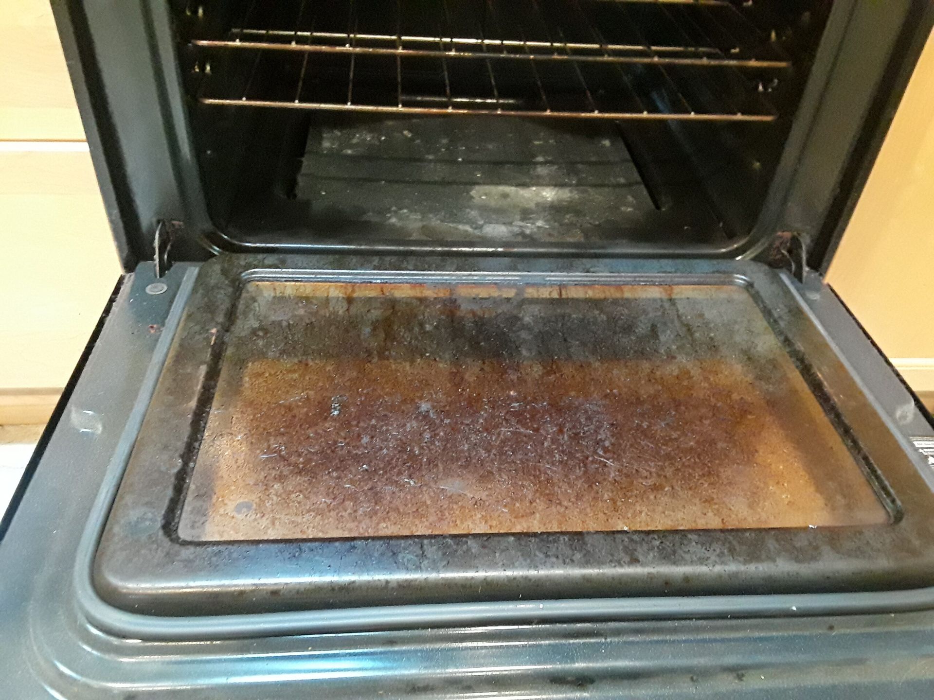The inside of an oven with a dirty glass door