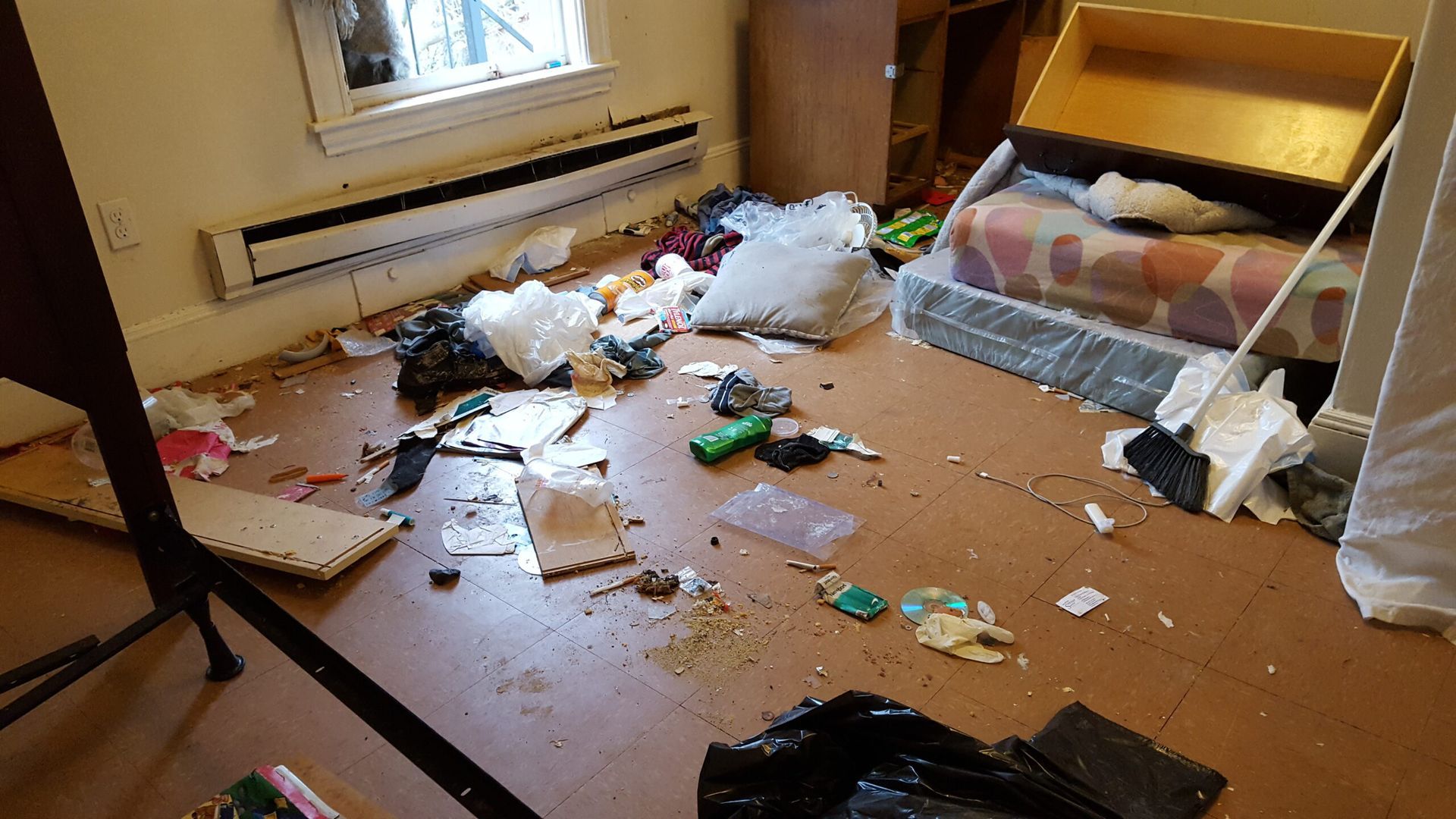 A room with a lot of trash on the floor.
