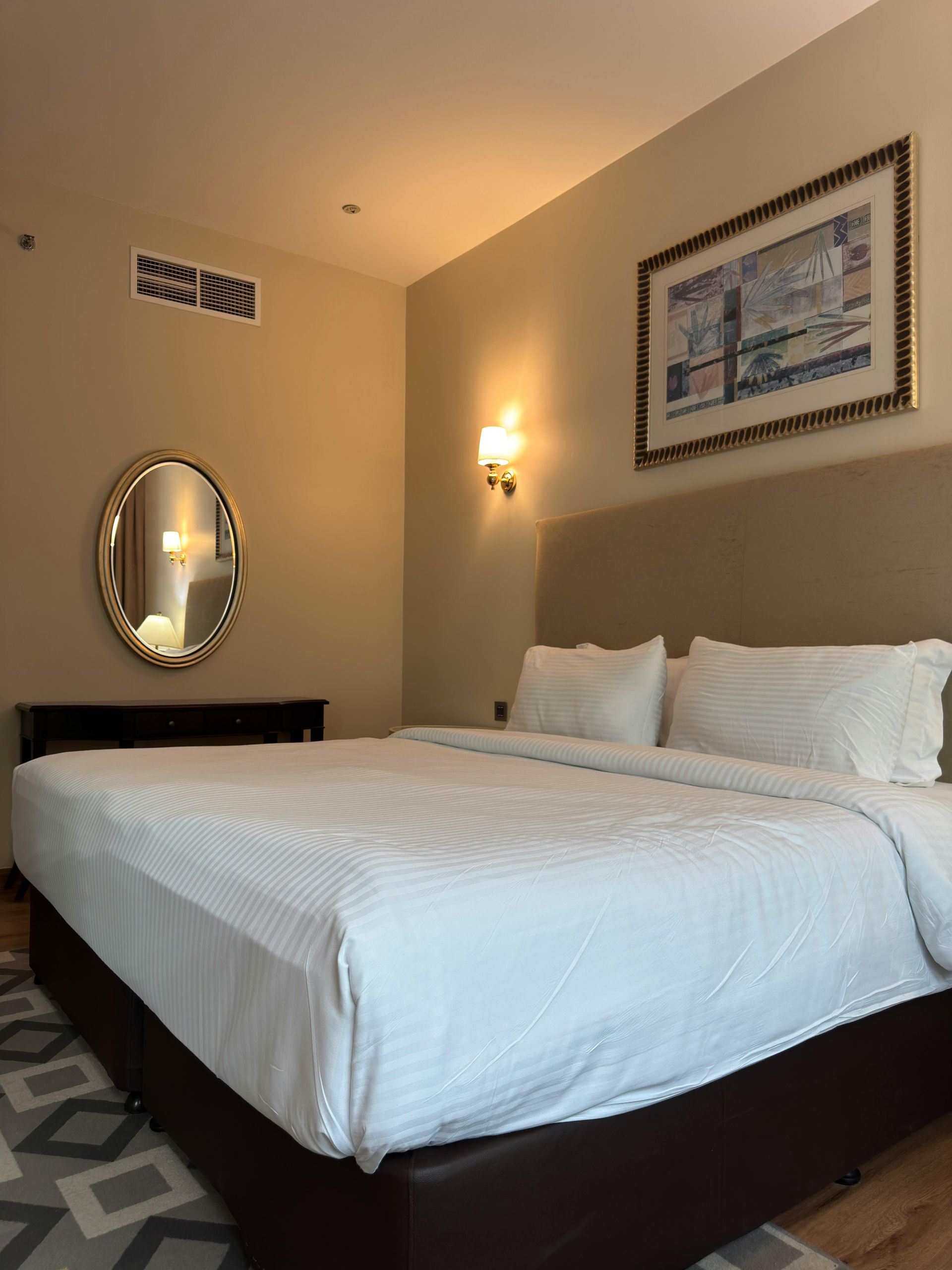 A bedroom with a messy bed and a clean bed