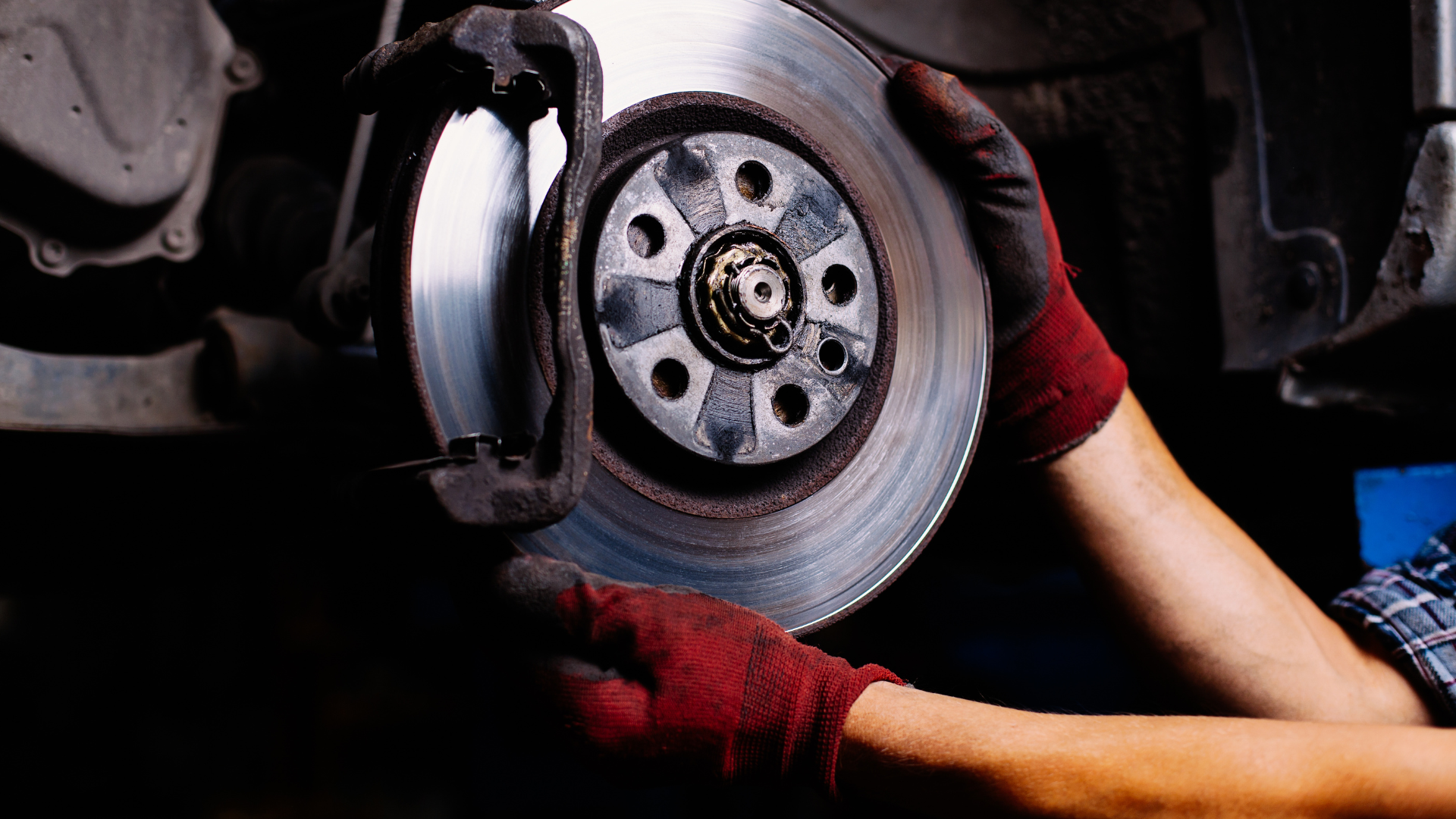 A person is fixing a brake disc on a car.