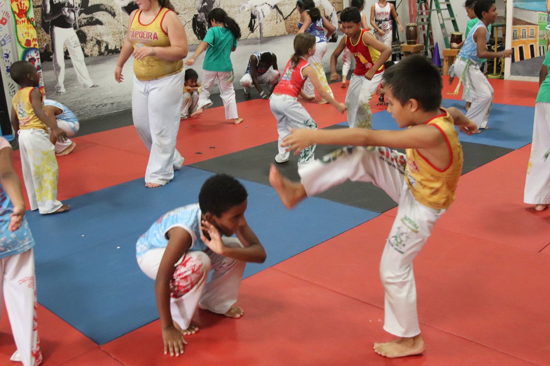 a boy and a girl are practicing taekwondo together .