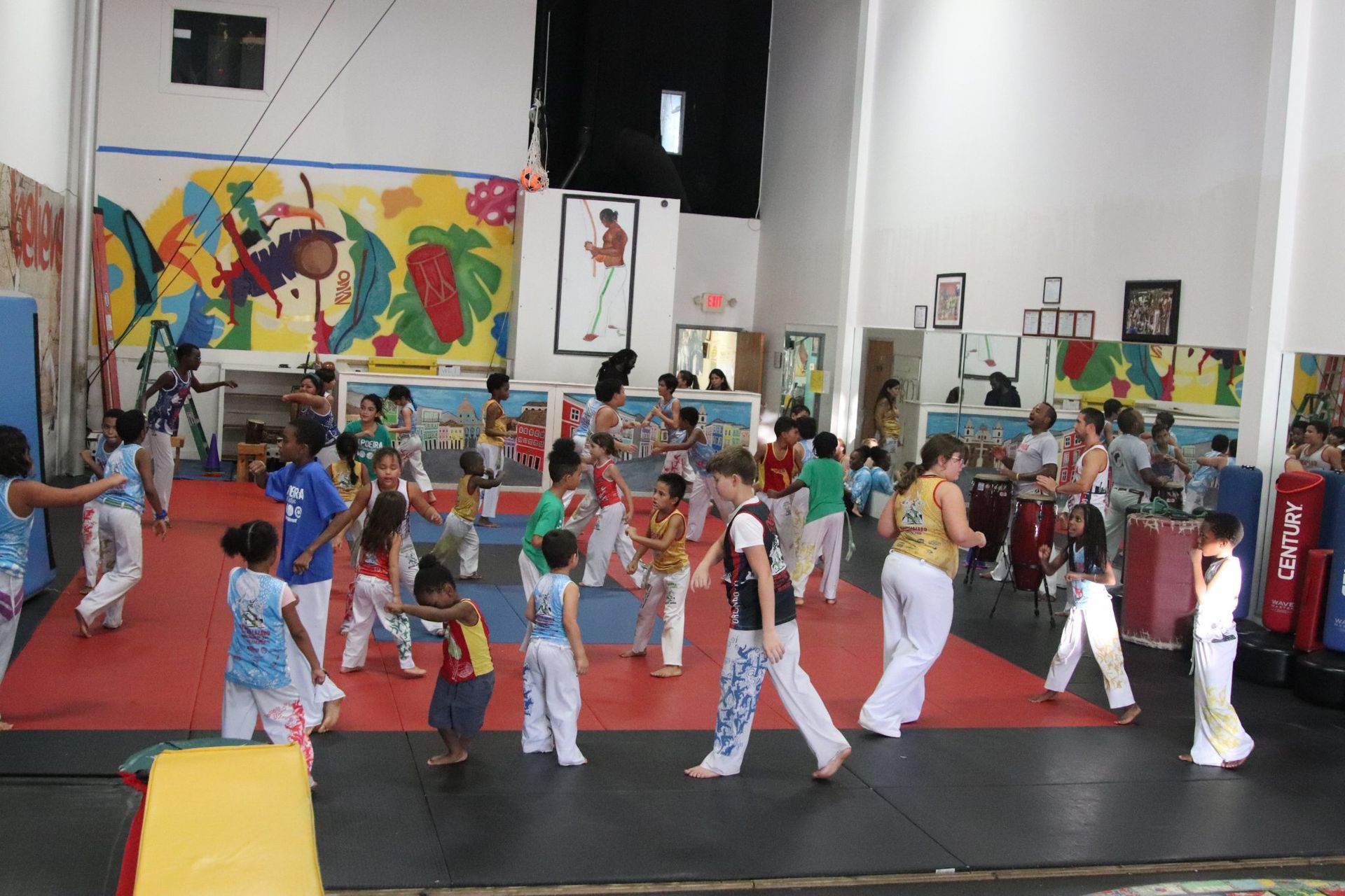a group of children are practicing martial arts in a gym