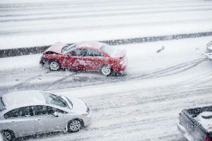 Car accident and snowy weather conditions cause car to swerve and get into an accident